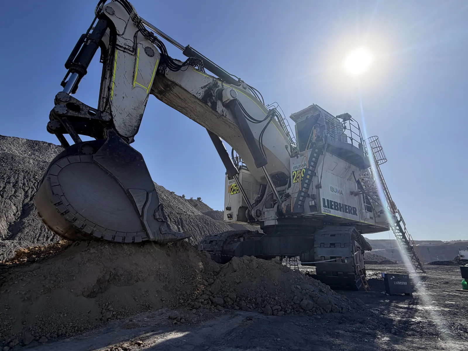 Liebherr excavator against the sun