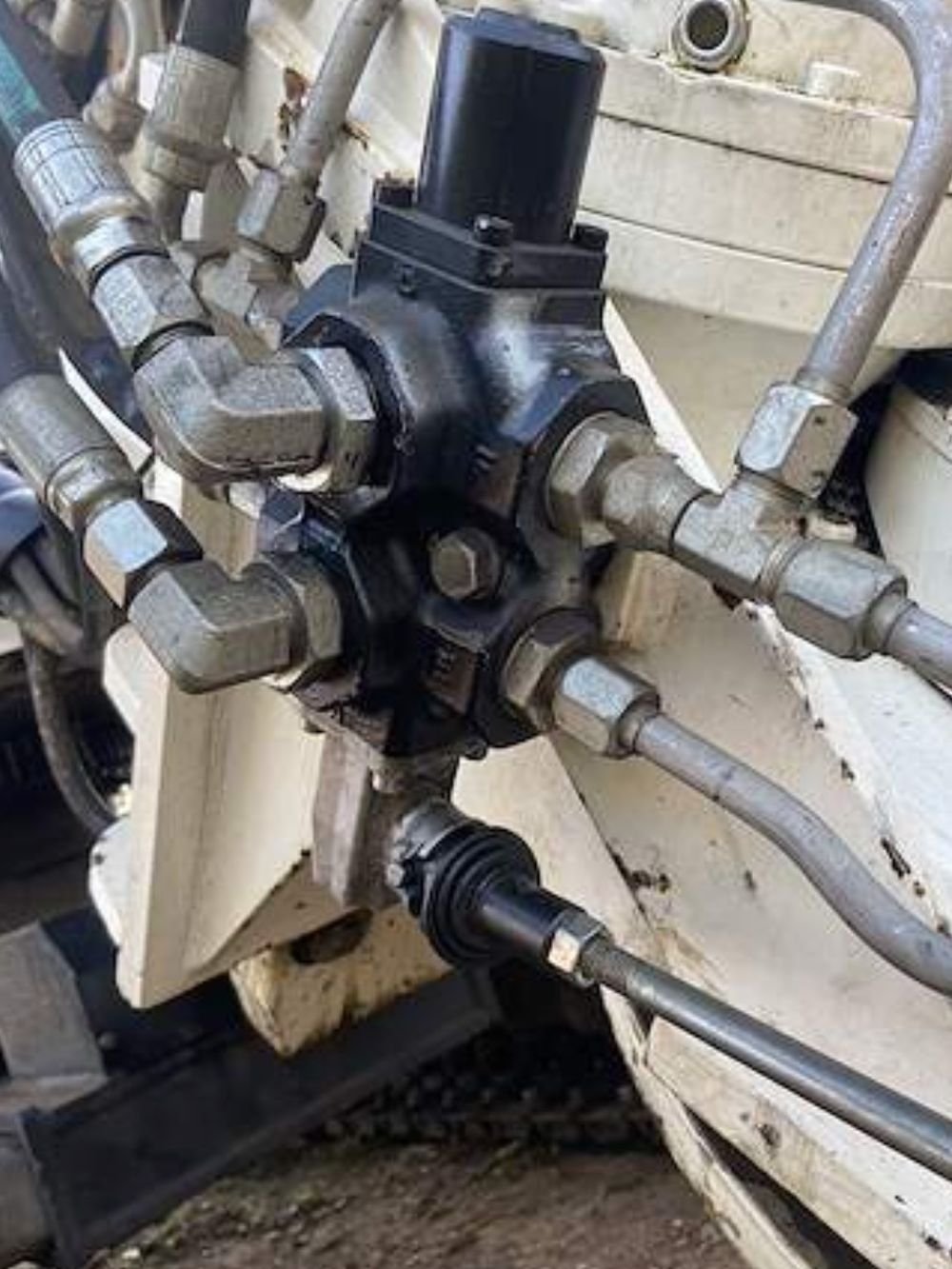Hydraulic control valve block with multiple crimped hose connections on a machine